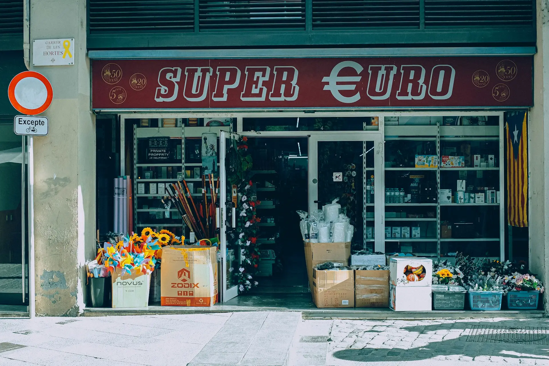a store front with a bunch of flowers in front of it